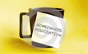 White paper with text Homeowners Association on the black cup