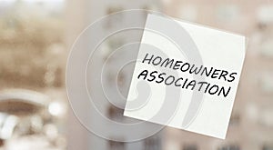 White paper with text Homeowners Association on the window