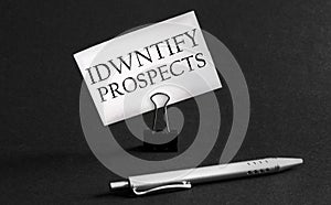 White paper with text Identify Prospects on a black background with stationery