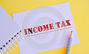 White paper with text income tax.Conceptual photo colloquial term for time on which individual income tax returns
