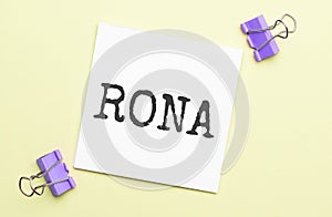 white paper with text rona on a yellow background with stationery photo