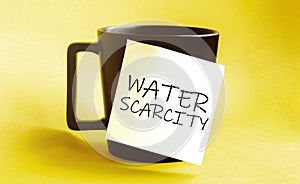 White paper with text Water scarcity on the black cup