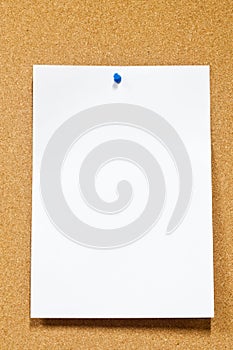 White paper with thumbtack on corkboard photo