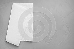 White paper towel on grey stone table, top view