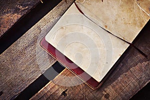 White papers in a copybook on the wooden desk