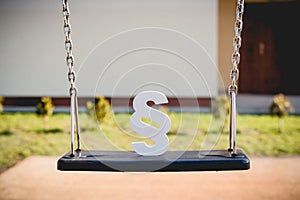 White paragraph symbol on children chain swing.