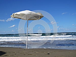 White Parasol Umbrella on Sandy Beach During Exotic Vacation