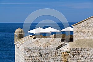 White Parasols over a Blue Sea