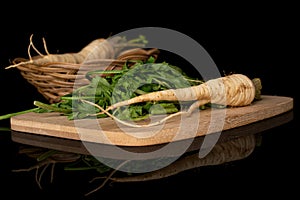 White parsley root isolated on black glass