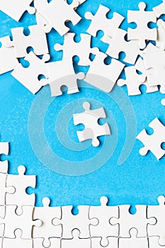 White part of jigsaw puzzle pieces on blue background. concepts of problem solving, business success, teamwork, Team playing