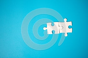 White part of jigsaw puzzle pieces on blue background. concepts of problem solving, business success, teamwork, Team playing