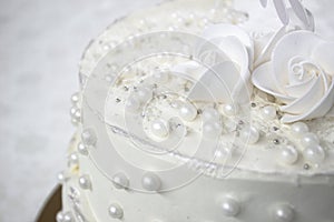 White party cake with white icing and pearls, cake design. Handmade cake made for a special celebratory occasion. Special details