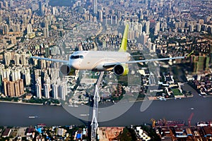 White passenger aircraft  flies over the skyscrapers of the business center of the big city. Front view of