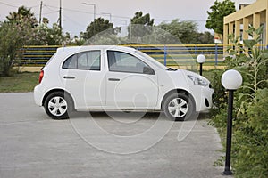 White passenger car parked on the parking