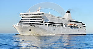 White passenger ferry ship sailing in still water photo