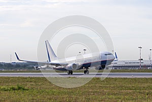 White passenger plane take off away from airport