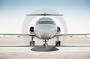 White passenger regional jet facing the camera.