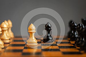 White pawn, in front of black, on a chessboard. Selective focus. Correct move. Strategy. Sport. Business.
