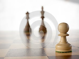 White pawn in front of black king and queen