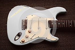 White pearl ivory electric guitar in a purple texture background