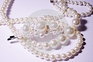 White pearl jewelry. Luxury jewelry for women and girls. Hair clip and pearl necklace. Artificial pearls. Snow-white