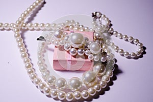 White pearl jewelry. Luxury jewelry for women and girls. Hair clip and pearl necklace. Artificial pearls. Snow-white