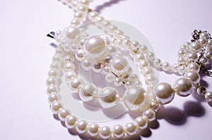 White pearl jewelry. Luxury jewelry for women and girls. Hair clip and pearl necklace. Artificial pearls. Snow-white