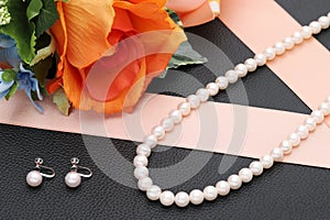 white pearl necklace and earrings