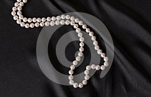 White pearls on black satin