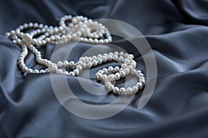 White pearls on blue satin