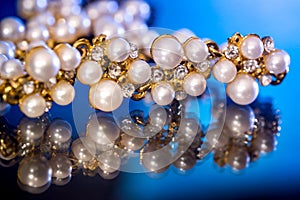 White pearls collier isolated on black blue