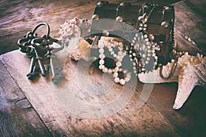 White pearls necklace in treasure chest next to seashells