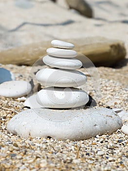 White pebble stack on a sandy beach