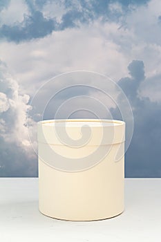 White pedestal against cloudy sky background