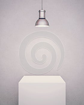 White pedestal illuminated with a lamp