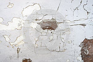 White peeling paint background with spots of peeking wood base