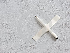 White pen taped on a wall