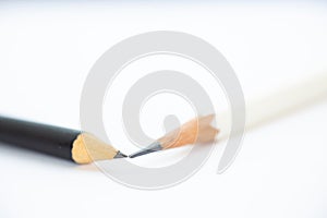 A white pencil with a black pencil on white background, Close up, Art creative idea, Stationery concept