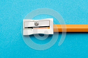 White Pencil Sharpener on Blue background