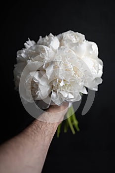 White peony wedding bouquet on darck background. White bridal bouquet. Wedding day.