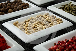 White pepper. Colorful spices in white bowls Seasonings for cooking.