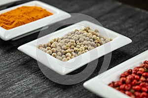 White pepper. Colorful spices in white bowls Seasonings for cooking. Natural Spices