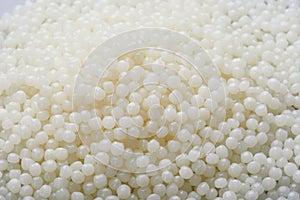 White PET granules, polymer resin, plastic granulate for injection molding process. photo
