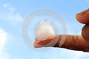 White petroleum jelly on finger in sky background