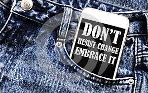 White phone with text Do Not Resist Change Embrace It lies in jeans pocket