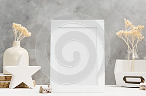 White Photo frame close up mock up with plants in vase with wooden and ceramic home decor on shelf. Scandinavian style