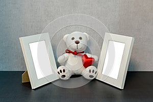 White photo frame and teddy bear toy