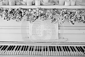 White piano with candles. Happy winter holidays concept.