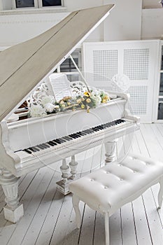 White piano in a white interior. Luxury interior.