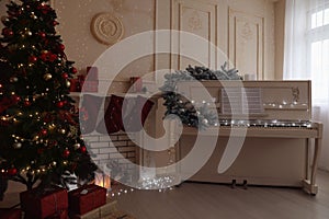 White piano with music sheets and beautiful Christmas tree in festive room interior